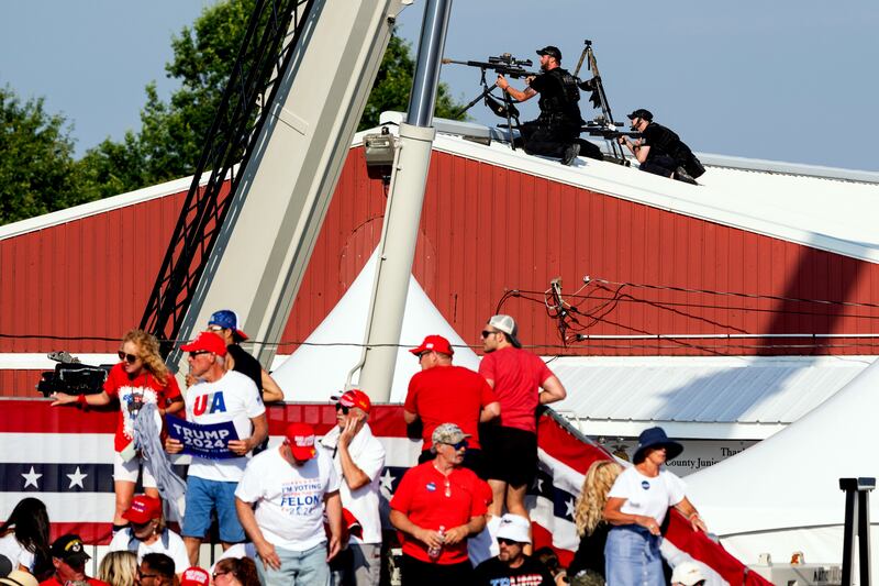 Law enforcement agents and members of the audience react after gunshots are heard at a campaign rally for former president Donald Trump in Butler, Pennsylvania on Saturday. Photograph: Eric Lee/New York Times
                    