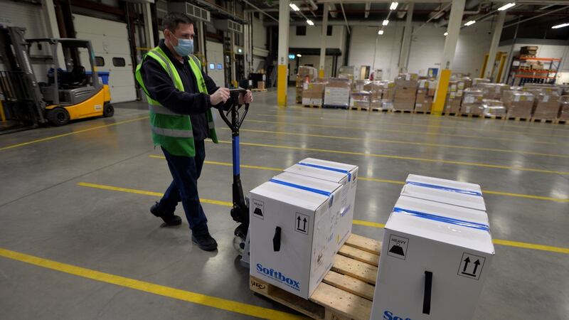 A member of the Cold Chain warehouse operations team moves ‘shipper’ boxes, which contain ‘pizza boxes’ boxes   of the Pfizer/BioNTech vaccine vials. Photograph: Alan Betson