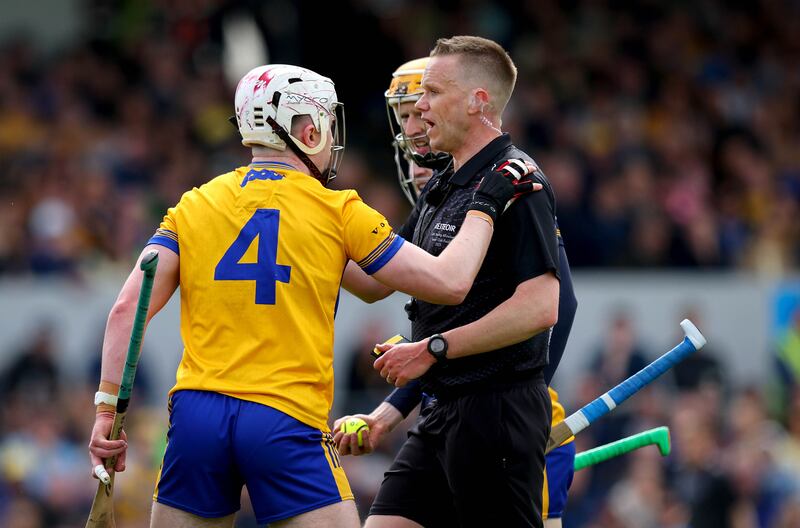 Clare’s Adam Hogan with referee Michael Kennedy at Cusack Park on Sunday.
Photograph: Ryan Byrne/Inpho