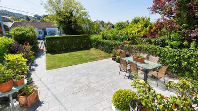 The small courtyard-style back garden, laid out in paving, gravel and lawn, is a sheltered and private spot, very sunny on a bright May morning