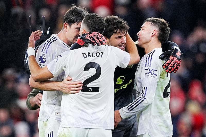 Manchester United's Harry Maguire (left), Diogo Dalot, goalkeeper Senne Lammens (centre right) and Manuel Ugarte (right) celebrate after the Premier League match at Anfield. Photograph: Peter Byrne/PA