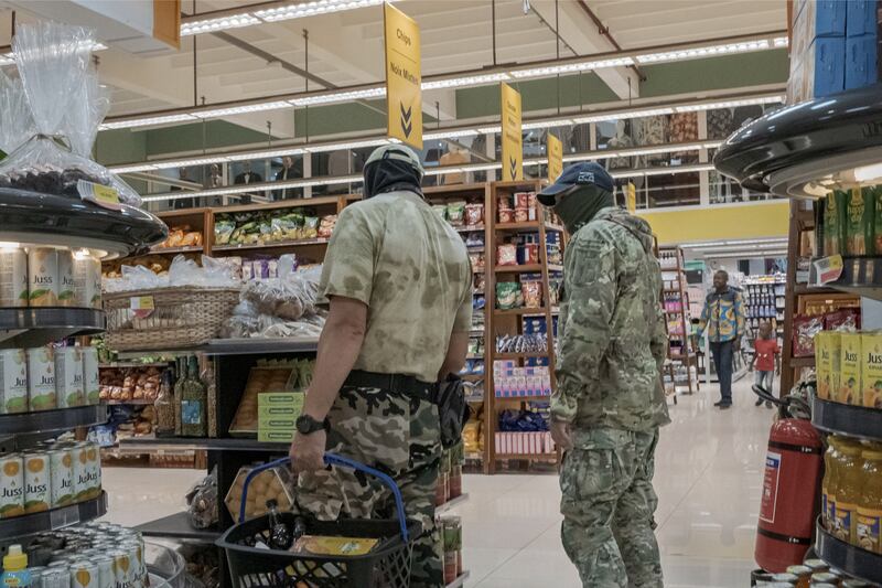 Russian mercenaries are seen shopping at a mall in Bangui, in Central African Republic. Photograph; Mauricio Lima/The New York Times
                      