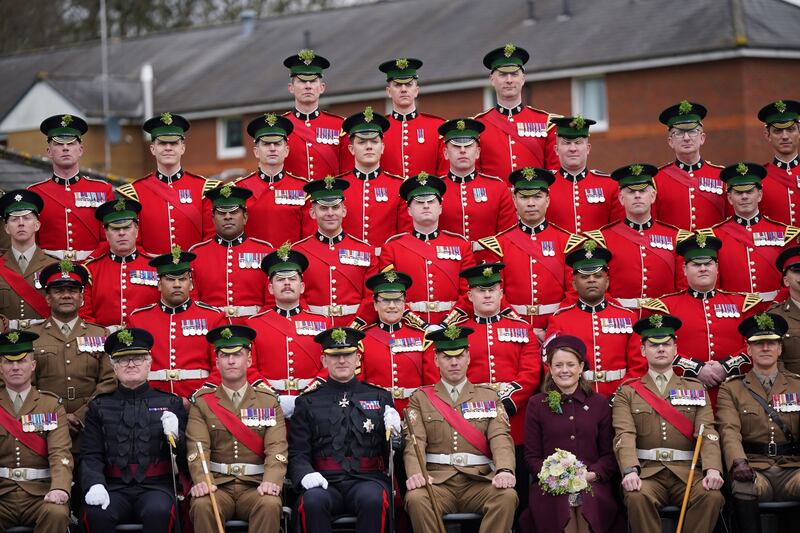 Regimental Lieutenant Colonel, Major General Sir Christopher Ghika, (fourth left) and his wife, Lady Ghika, posing with
members of the Irish Guards for a family picture at Mons Barracks, Aldershot, following a St Patrick's Day parade. 