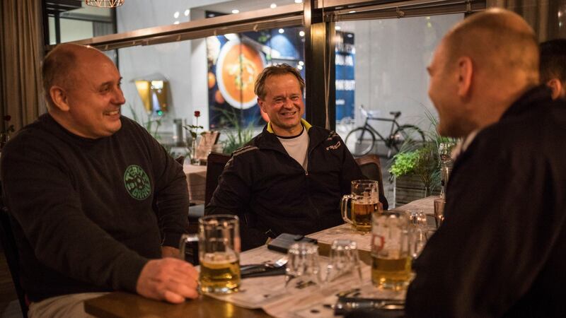 After soccer practice, Antti Raunemaa, from left, Nicke Tevajarni and Johan Hilli have a drink at Moms, the only late-night bar in Kauniainen, Finland. Photograph: (Lena Mucha/The New York Times