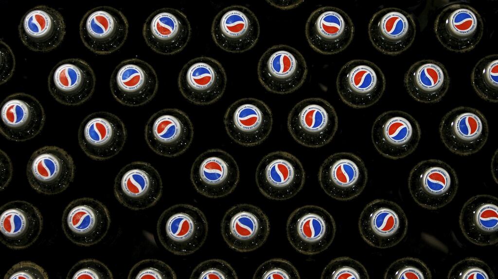 Pepsi bottles sit on a conveyor belt at drinks company Britvic’s bottling plant in London. Photograph: Luke MacGregor/Files/Reuters