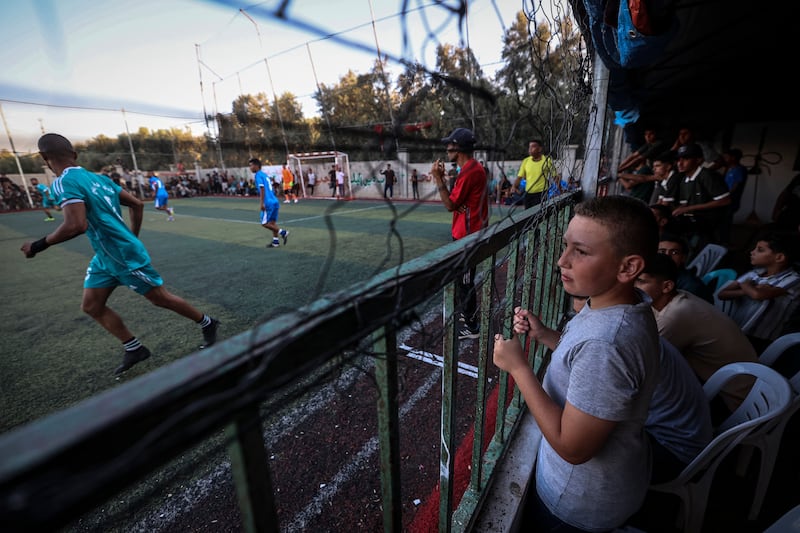 Spectators watch the opening match between Shabab Rafah and Khadamat Rafah teams during the Thousand Martyrs Cup football tournament. Photograph: Eyad Baba/AFP/Getty.