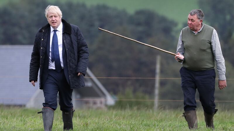 Boris Johnson is shown around by farmer Peter Watson  at Darnford Farm. Photograph:  Andrew Milligan/AFP/Getty