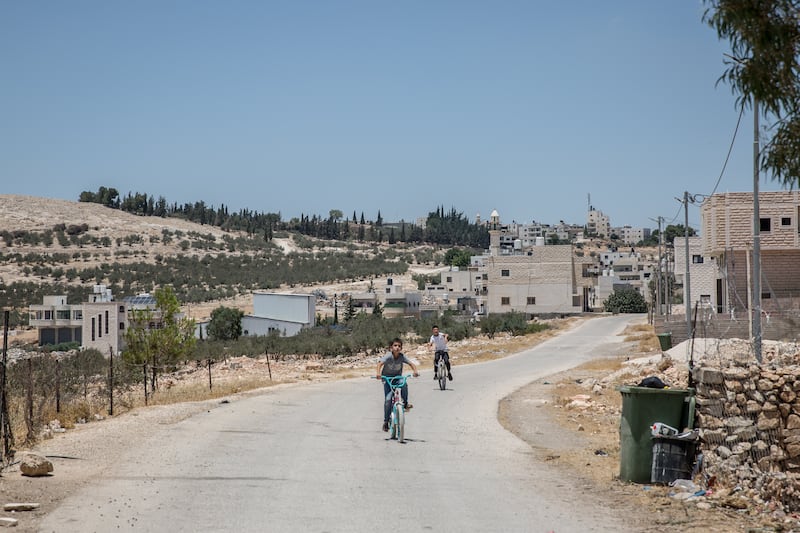 Boys ride bicycles through the Palestinian town of Tequ. Photograph: Sally Hayden