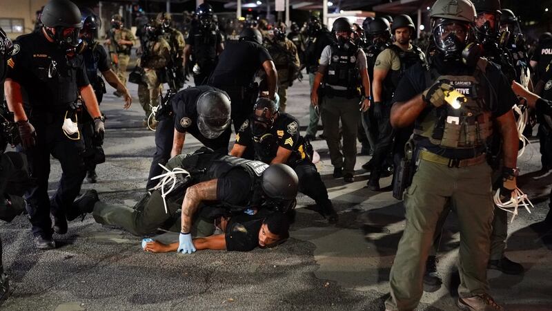Police detain a protester during a protest in response to the police killing of George Floyd  in Atlanta, Georgia. Photograph: Elijah Nouvelage/Getty Images