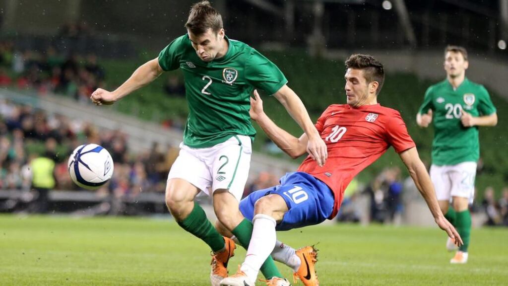 Seamus Coleman holds off Dusan Tadic during last night’s match against Serbia. Photograph: Cathal Noonan/Inpho