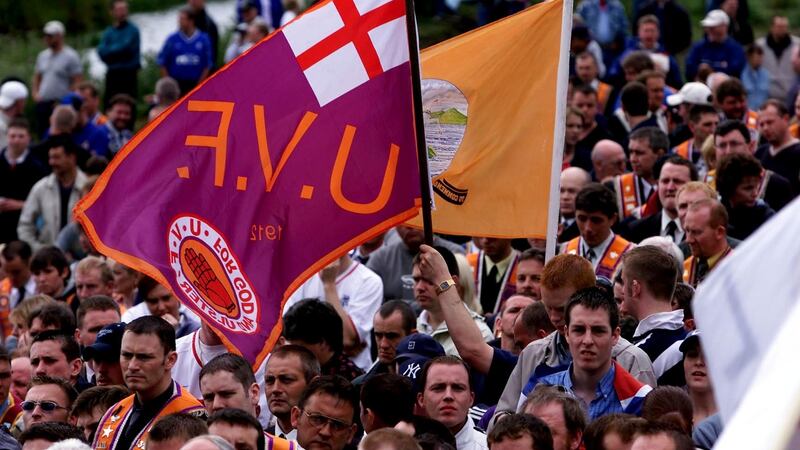 A UVF fllag among the protestors at Drumcree Church where their parade ended at the steel barrier erected by the security forces in 2000. Photograph: Bryan O’Brien
