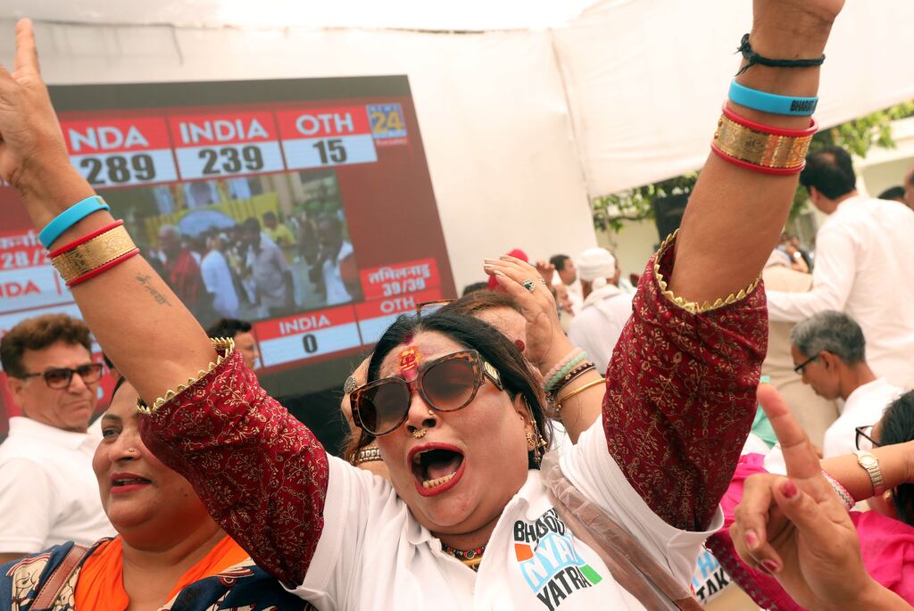 Indian National Congress Party supporters celebrate as they watch election results on a television screen at Congress headquarters in New Delhi. Photograph: Harish Tyagi/EPA