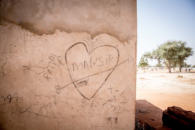 Children's drawings in charcoal on the walls of homes in Chadakori opportunity village