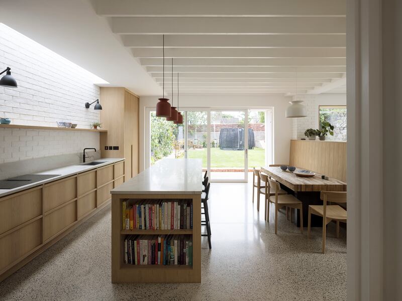 Oak kitchen with matching dining bench and chairs with polished concrete floor. Photograph: Aisling McCoy