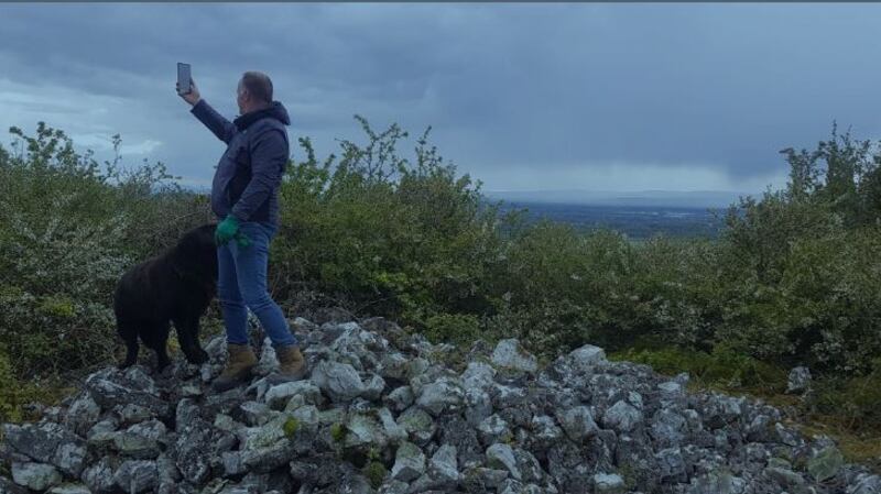 Shane McGrath on top of Coolnacarrick Cairn with Portlaoise in the background
