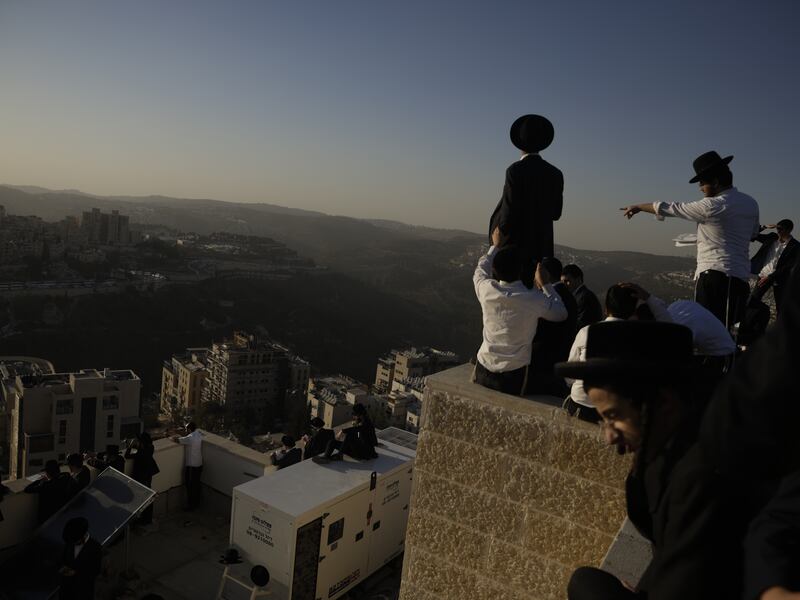Ultra-Orthodox Israelis stand on rooftops during a protest against military conscription. Photograph: Amir Levy/Getty Images