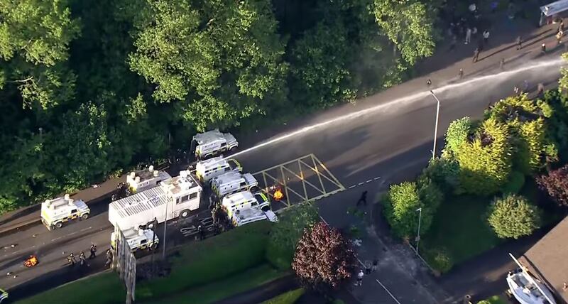 Sky News helicopter footage of police deploying a watercannon "in an attempt to maintain public order".