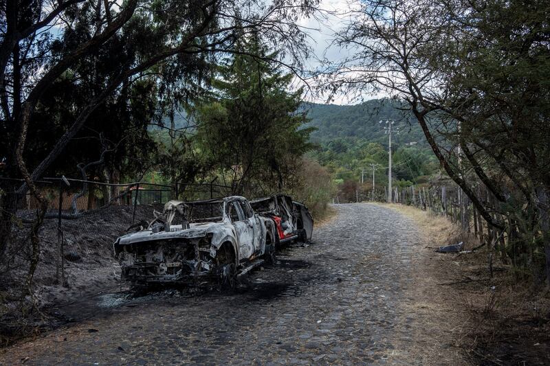 Burned vehicles along the road leading to Cabañas La Loma, near Tapalpa, Mexico. Photograph: César Rodríguez/The New York Times