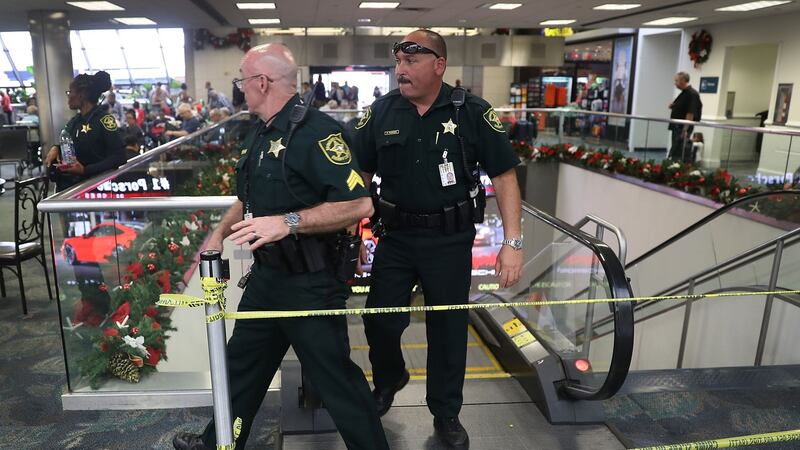 Broward County Sheriff officers exit from the escalator that takes people from the baggage area of Terminal 2. Photograph:  Joe Raedle/Getty Images