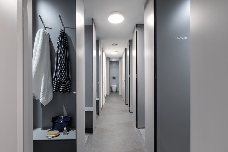 The communal bathroom has shower cubicles with dressing spaces and lockable doors