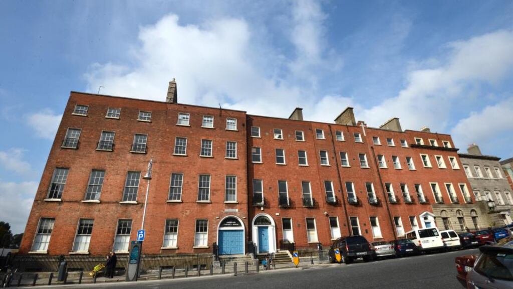 The library will move to the Coláiste Mhuire buildings on the north side of the Georgian square, above. Photograph: Dara Mac Donaill