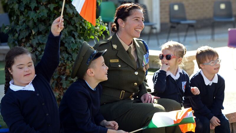 Sgt Amy Hopkins with children from St Raphael’s Special School,  Celbridge, Co Kildare, at a Defence Forces ceremony heralding the centenary of the 1916 Rising.  Photograph: Eric Luke/The Irish Times