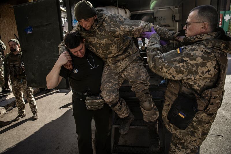 A Ukrainian soldier with a shrapnel wounds to his leg arrives at a field hospital three miles from frontline fighting positions in the city of Bakhmut. Photograph: Finbarr O’Reilly/The New York Times