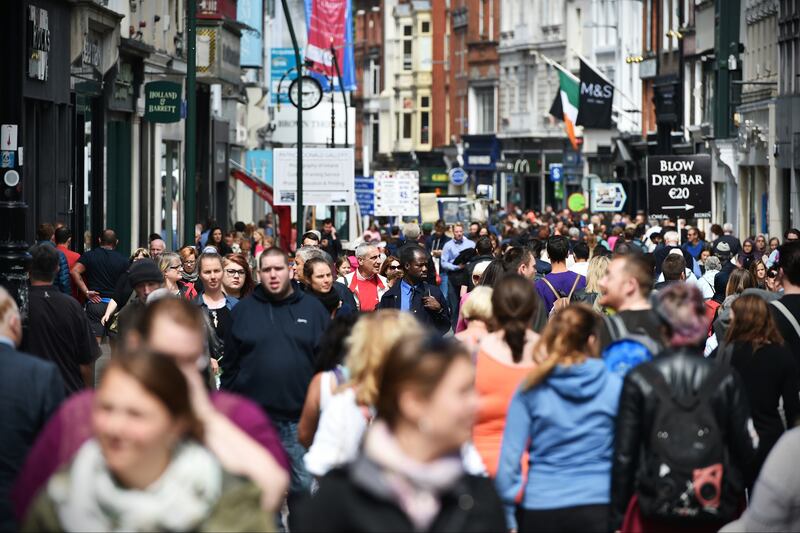 Dublin city with people Dublin, Ireland - July 22, 2015: Crowds of people walk on Grafton Street. The street is a main tourist attraction in the Irish capital, renowned for its lively atmosphere and shops.