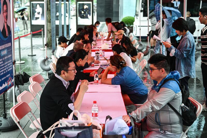 A job fair in in Shanghai. Photograph: Hector Retamal/AFP via Getty