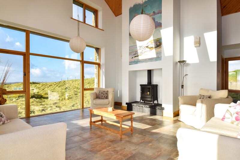 The livingroom is warmed by a stove