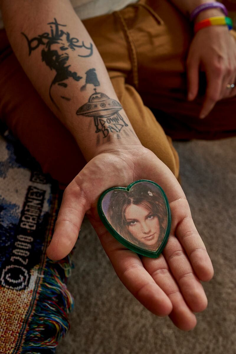 Zachary Gordon-Abraham with an image of Britney Spears from his collection of Spears memorabilia at his home in Pennsylvania. Photograph: Noah Kalina/The New York Times
                     