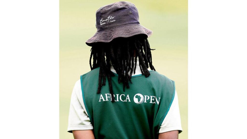 A local caddie during the second round of the Africa Open at the East London Golf Club in East Cape, South Africa, yesterday. - (Photograph: Stuart Franklin/Getty Images)