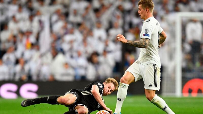 Ajax’s Frenkie de Jong slides in to challenge Real Madrid’s  Toni Kroos  during the Champions League round of 16 second leg  match at the Santiago Bernabéu stadium.  Photograph: Gabriel Bouys/AFP/Getty Images