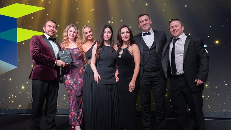 Eoin Joy, awards judge, presents the fit out project of the year - small office (under €500k) award to Della Interiors team