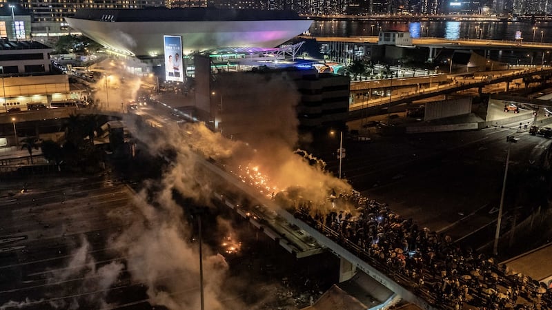 Protesters and police clash on a bridge at The Hong Kong Poytechnic University in Hong Kong. Photograph: Anthony Kwan/Getty Images.