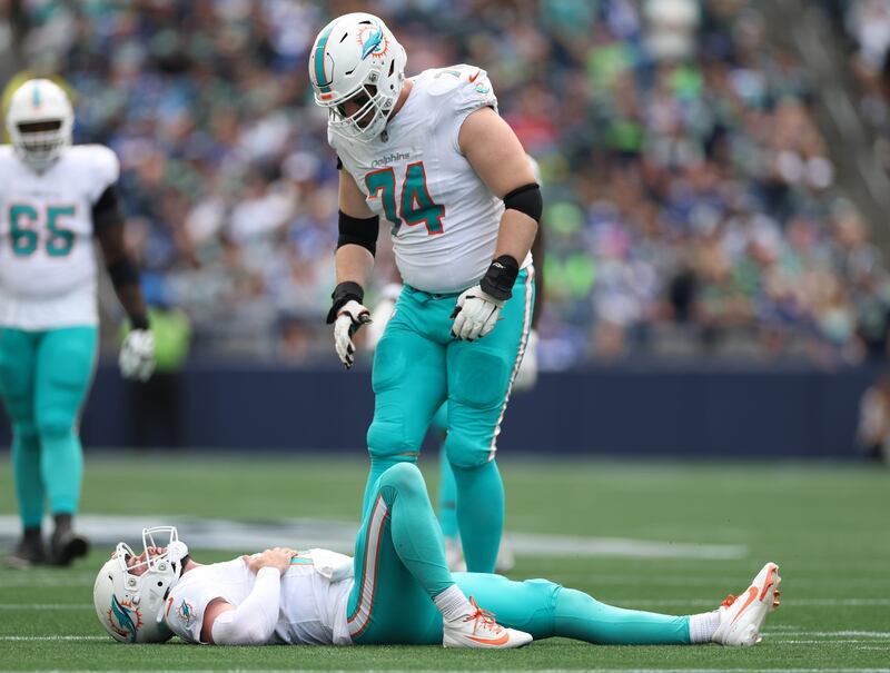 Miami Dolphins' Liam Eichenberg looks on as his team-mate Skylar Thompson lies on the ground injured. Photograph: Steph Chambers/Getty Images