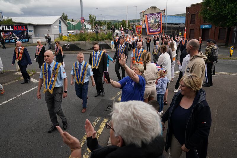 An Orange Order parade passes the Ardoyne shops on the Crumlin Road in Belfast. Photograph: Brian Lawless/PA Wire