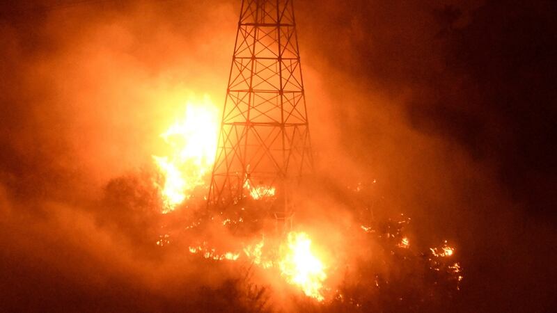 Fires burn around power line towers  in Coyote Canyon near Montecito. Photograph: Reuters