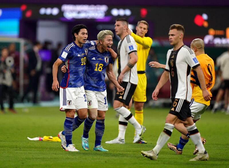 Japan's  Takumi Minamino and Takuma Asano celebrate victory over Germany. Photograph: Mike Egerton/PA Wire