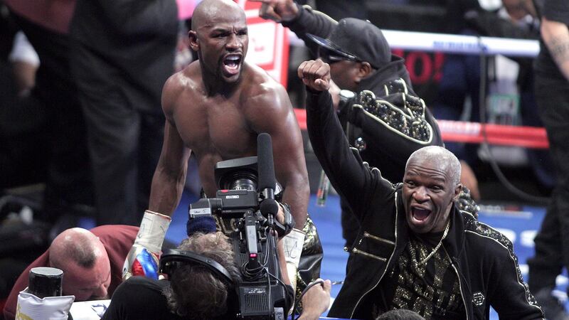Floyd Mayweather Jr and his father Floyd Mayweather Sr celebrate his victory. Photograph: John Gurzinski/Getty Images
