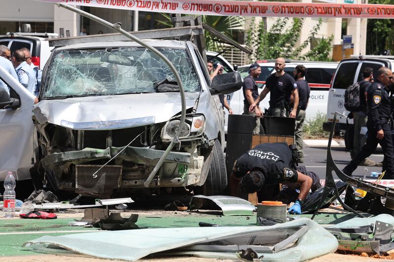 Israeli security and emergency personnel work at the site of a car ramming attack in Tel Aviv on Tuesday, after a Palestinian man drove a vehicle into Israeli civilians, injuring at least eight, before trying to stab some of them and being fatally shot by a passerby. Photograph: Jack Gudez/AFP via Getty 