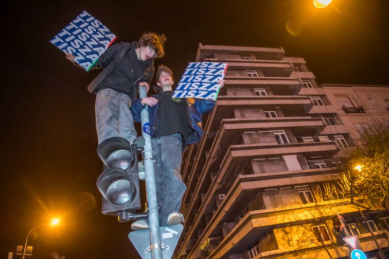 People celebrate in the streets after Peter Magyar, leader of the pro-European conservative Tisza party, addressed supporters at their election night party in Budapest. Photograph: Ferenc Isza/AFP/Getty Images