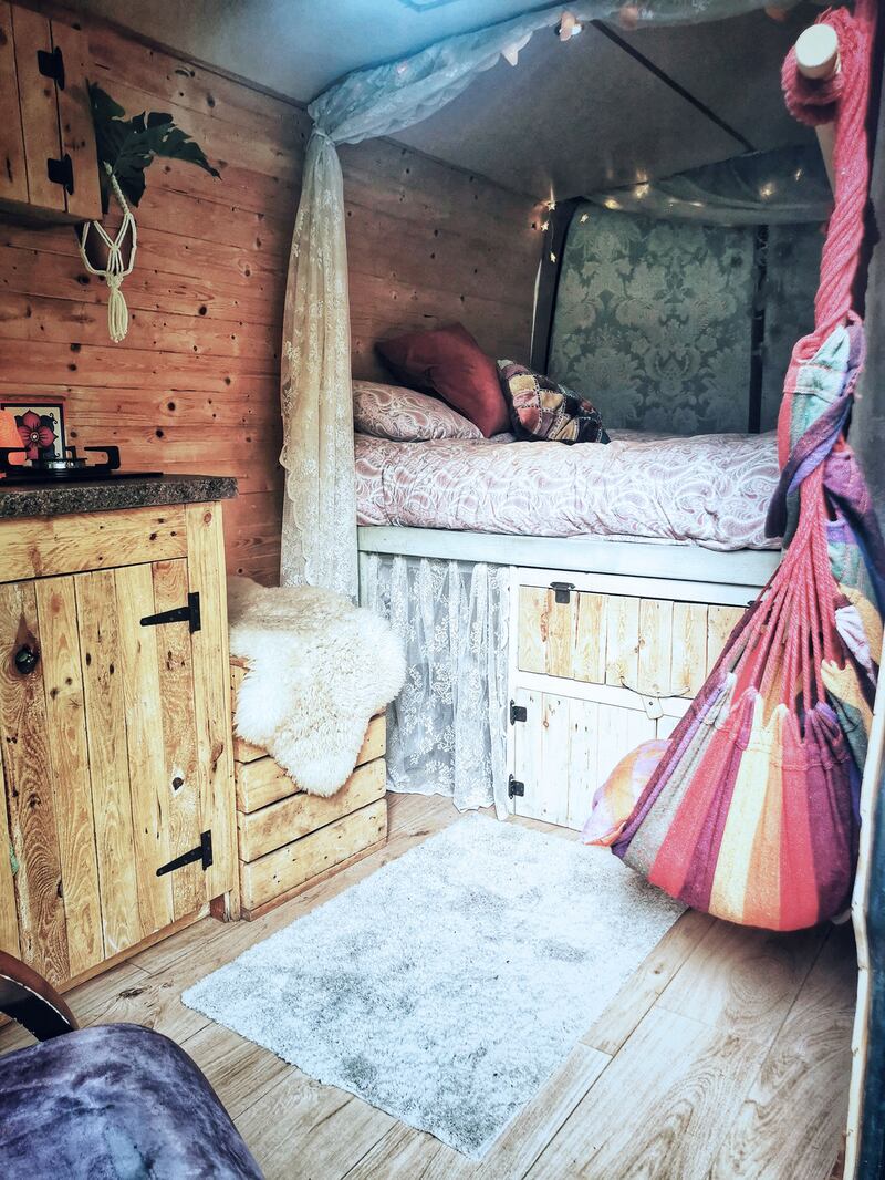 Van life: Tracy Gallagher’s raised bed shrouded in lace netting, with storage and a fridge underneath