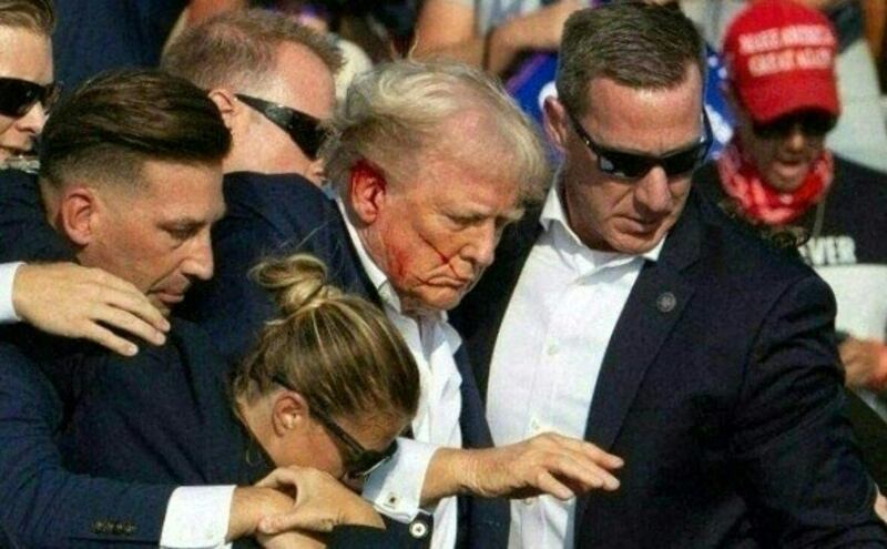 Donald Trump is taken off stage with blood on his face surrounded by secret service agents after his attempted assassination on July 13th. Photograph: Rebecca Droke/AFP via Getty