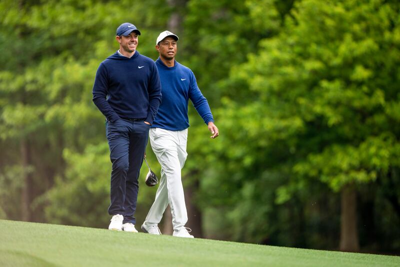 Tiger Woods and Rory McIlroy walk down the 11th fairway at Augusta National Golf Club on Monday. Photograph: Doug Mills/New York Times
                      