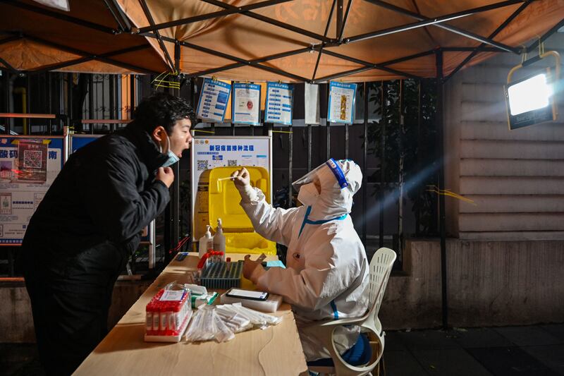 A health worker is tested for Covid-19 in Shanghai on December 9th. Photograph: Hector Retamal/AFP via Getty Images