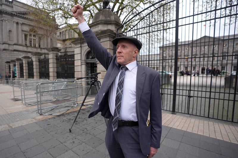 Independent TD Michael Healy-Rae waves to the crowds gathered outside Leinster House, Dublin, after resigning in the Dail as Minister of State. Photograph: Niall Carson/PA Wire