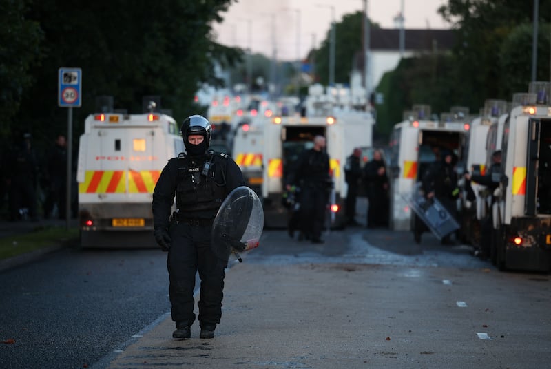 A police officer walks in riot gear at the scene of disorder on Antrim Road in Newtownabbey, north Belfast on Wednesday. Photograph: Adam Vaughan/EPA