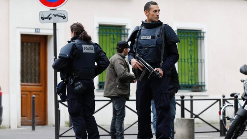 French police officers establish a perimeter during a police operation in  Paris on Saturday.  There are unconfirmed reports that shots were fired near a synagogue in the city’s 19th district. Photograph: Etienne Laurent/EPA.