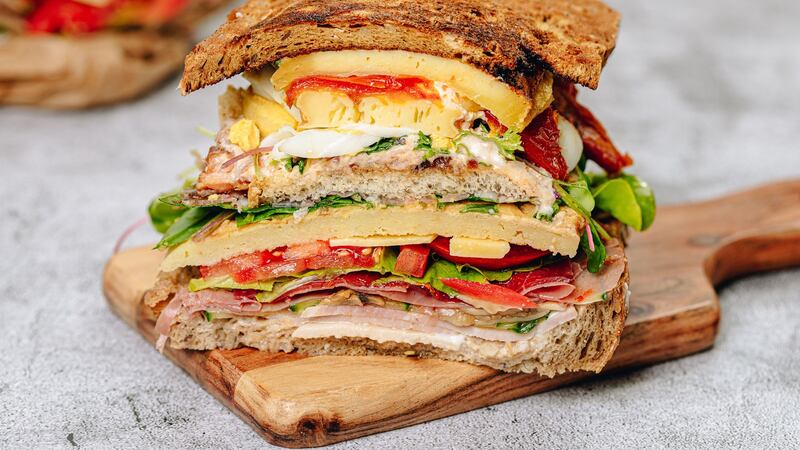 The gargantuan sandwich is arranged in three layers, meat, fish and cheese.